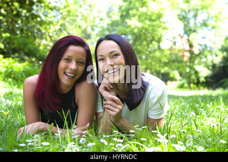 Close up portrait of a two sisters smiling together outdoors Stock Photo