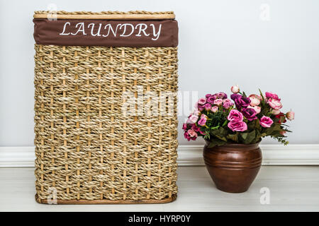 Light brown knitted basket on brown wooden background Stock Photo