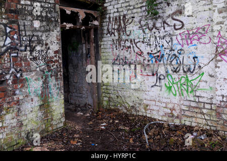 A room inside an industrial warehouse that has been filled with Graffiti Stock Photo