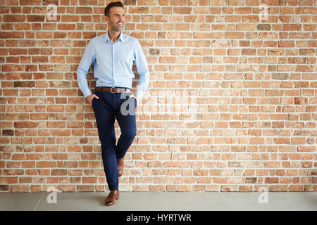 Handsome man on brick wall Stock Photo
