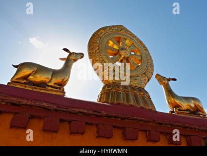 Dharmachakra, or Wheel of Law which represents the teachings of the Buddha and endless cycle on the gilded roof of Jokhang Temple, Lhasa, Tibet. Stock Photo