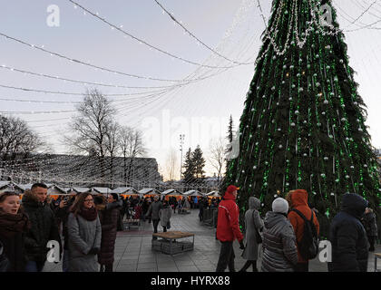 Vilnius, Lithuania - December 4, 2016: People having fun at the Christmas market near Cathedral Square in the old town, Vilnius, Lithuania. Stock Photo
