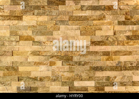 Modern pattern of decorative natural stone wall surface texture pattern. Rock stone brick tile wall made of grunge ancient rustic limestone. Stock Photo