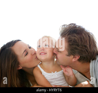 Portrait of happy parents kissing baby girl Stock Photo