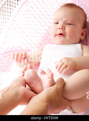 Close up portrait of a mother holding cute baby feet Stock Photo