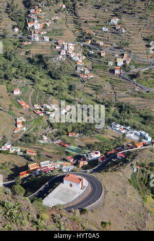 VALLE GRAN REY, LA GOMERA, SPAIN: View of the valley with terraced fields and mountains. Winding road and the church of San Antonio de Padua in the fo Stock Photo