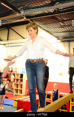 SNP leader and First Minister Nicola Sturgeon tries out on the beam on a campaign visit to a children's gymnastic club in Cumbernauld Stock Photo