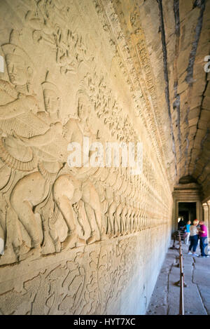 Vertical view of intricate carvings on the walls of Angkor Wat in Cambodia. Stock Photo