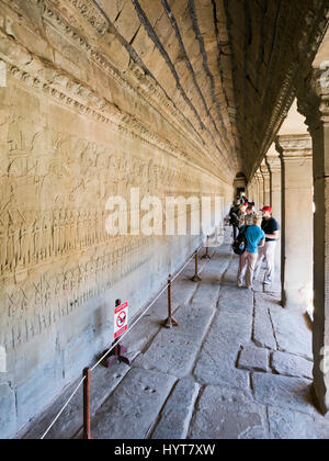 Vertical view of intricate carvings on the walls of Angkor Wat in Cambodia.
