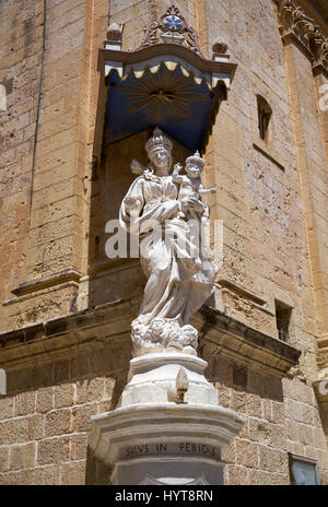 The niche with the Statue of Virgin Mary with Jesus child on the corner of Carmelite Priory also known as Our Lady of Mount Carmel in Mdina. Malta Stock Photo