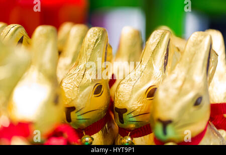 Easter bunny Lindt chocolate on shelves in supermarket for sale wrapped in golden foil. Lindt & Sprüngli  produces the highest quality premium chocola Stock Photo