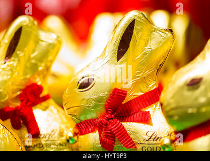 Easter bunny Lindt chocolate on shelves in supermarket for sale wrapped in golden foil. Lindt & Sprüngli  produces the highest quality premium chocola Stock Photo