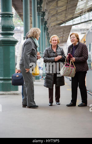 Four older women welcome on platform train station in Porto, Portugal Stock Photo