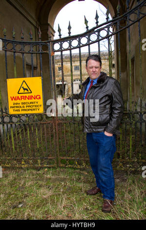 The Earl of Cardigan at his home in the Lodge (white painted) and in front of the family seat Tottenham House also showing the stable block Stock Photo