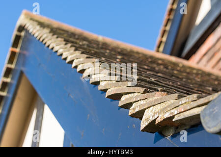 Roof tiles on a sloping roof on a 1930's mock tudor style British house in the UK. Stock Photo