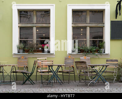 Wooden chairs and tables in front of a restaurant Stock Photo