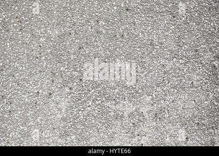 Small stones in concrete wall, texture or background. Stock Photo