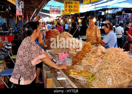 Nakhon Pathom, Thailand - January 9, 2010:   Women selling Thai foods at a local marketplace located outside Wat Phra Pathom Chedi Stock Photo