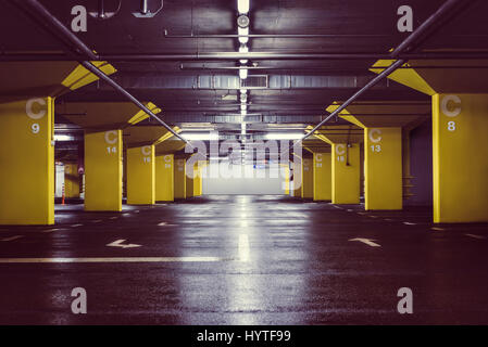 Interior of empty underground parking garage at night Stock Photo