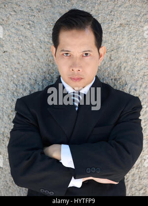 Close up portrait of a businessman posing with arms crossed and angry expression Stock Photo