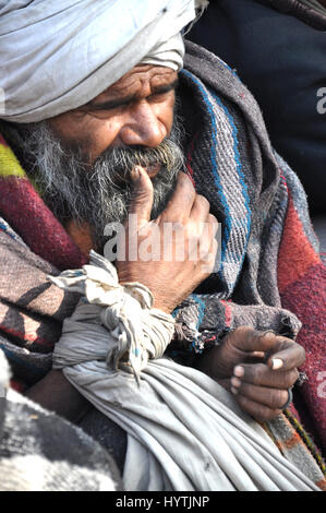 Street People, Street People waiting for food, outside Temple. Delhi (Photo Copyright © by Saji Maramon) Stock Photo