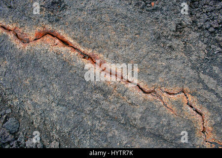 Red crack in purple rock in Iceland Stock Photo