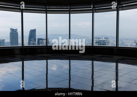 Room with smooth floors, lots of windows with views of modern buildings Stock Photo