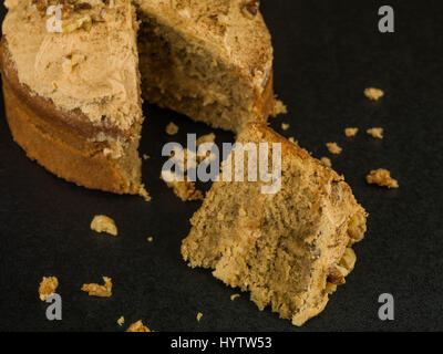 Baked Coffee and Walnut Cake Against a Black Background Stock Photo