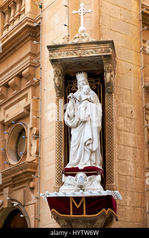 The statue of the Virgin Mary and baby Jesus on the corner of Basilica of Our Lady of Mount Carmel, Valletta, Malta Stock Photo