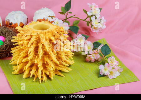 Homemade traditional easter LITHUANIAN SAKOTIS CAKE Kulitch Kulich Easter Bread colored eggs on painted towel Stock Photo
