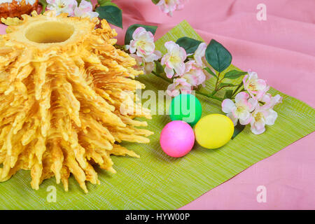 Homemade traditional easter LITHUANIAN SAKOTIS CAKE colored eggs on painted towel Stock Photo