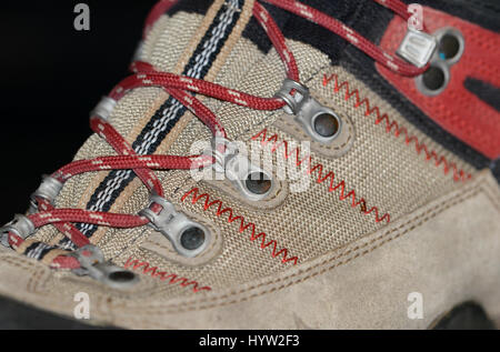 Waterproof leather and synthetic hiking boots closeup wih shoelaces also used for mountaineering, climbing, hunting, trekking or in many lines of work Stock Photo