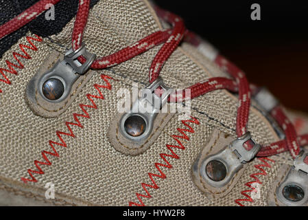 Waterproof leather and synthetic hiking boots closeup wih shoelaces also used for mountaineering, climbing, hunting, trekking or in many lines of work Stock Photo