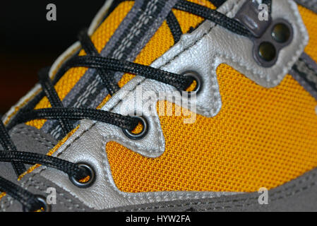 Waterproof leather and synthetic hiking boots closeup wih shoelaces also used for mountaineering, climbing, hunting, trekking or in many lines of work Stock Photo