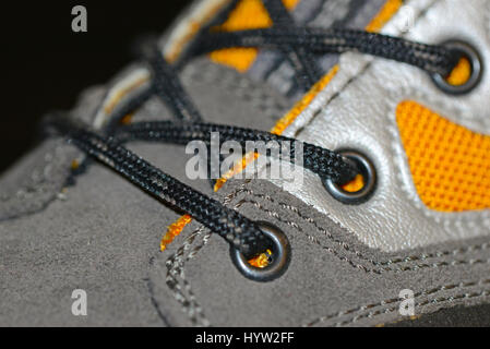 Waterproof leather and synthetic hiking boots closeup wih shoelaces also used for mountaineering, climbing, hunting, trekking or in many lines of work Stock Photo