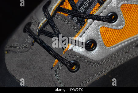 Waterproof leather and synthetic hiking boots closeup wih shoelaces also used for mountaineering, climbing, hunting, trekking or in many lines of work Stock Photo