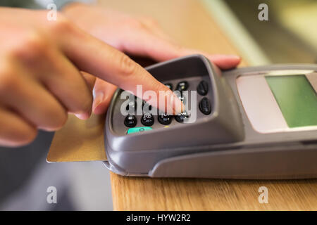 close up of hand entering code to money terminal Stock Photo