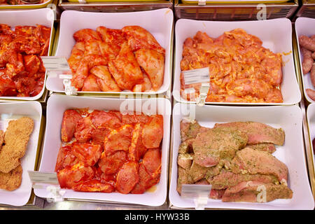 marinated meat in bowls at grocery stall Stock Photo