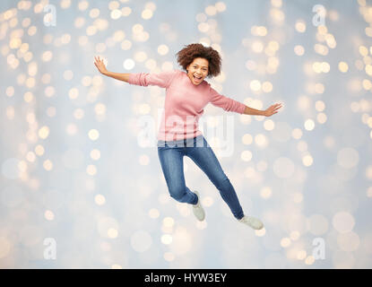 happy african american woman jumping over white Stock Photo