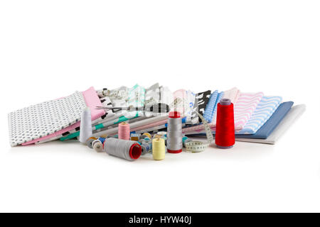 cotton fabric material, tailor measurement tape with scissors and spools of thread cotton isolated on white Stock Photo