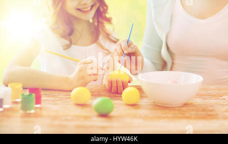 close up of family coloring easter eggs Stock Photo