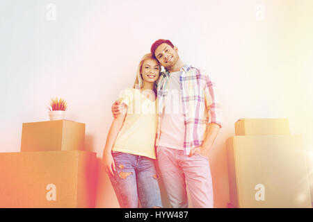 smiling couple with big boxes moving to new home Stock Photo