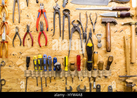 work tools hanging on wall at workshop Stock Photo