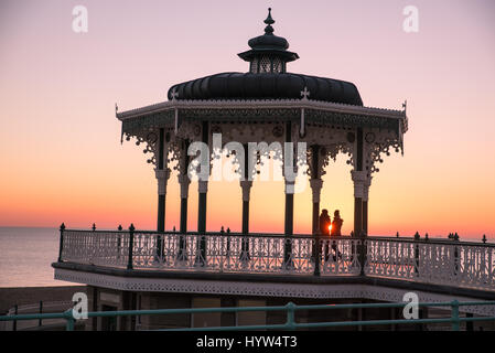 1st december, 2016, Brighton, UK. People watchiong the sunset from Brighton Bandstand Stock Photo