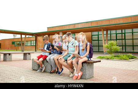 group of happy elementary school students talking Stock Photo