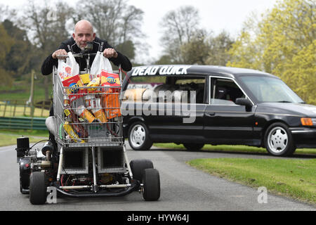 Matt McKeown on board the World's fastest shopping trolley as he unveils his converted 1992 Ford Cardinal hearse 'Dead Quick' at the Prescott Hill Climb in Gloucestershire. Stock Photo
