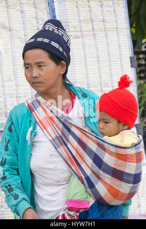Hill tribe woman with baby in a sling, Chiang Dao, Chiang Mai province, Thailand Stock Photo