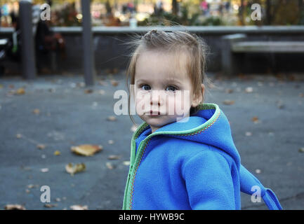 Adorable one and a half year old girl on a playground. Stock Photo