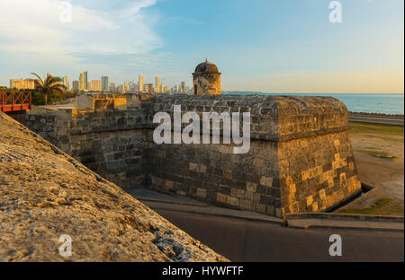 The San Felipe fortress and the modern city of Cartagena in the background by the Caribbean Sea at sunset, Colombia. Stock Photo