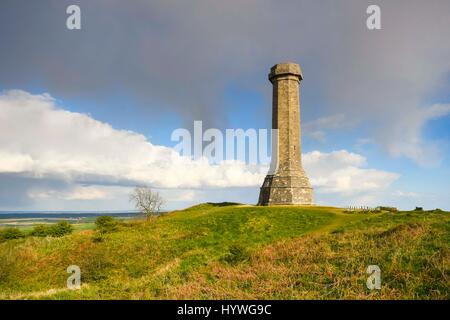 Portesham, Dorset, UK.  26th April 2017.  UK Weather.  Sunshine at Hardy Monument near Portesham in Dorset with a dark shower cloud overhead.  Hardy's Monument comemorates Vice Admiral Sir Thomas Masterman Hardy who was Flag Captain under Nelson aboard HMS Victory at the battle of Trafalgar.  Hardy lived in the nearby village of Portesham.  The monument is owned by the National Trust.  Photo Credit: Graham Hunt/Alamy Live News Stock Photo